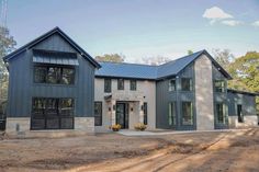 a large gray house with lots of windows