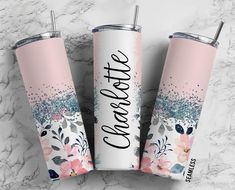 three personalized tumbles with floral designs and the words congratulations on them, sitting on a marble surface