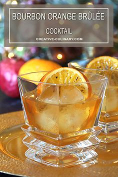 two glasses filled with lemonade sitting on top of a gold tray next to christmas decorations