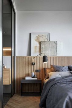 a bed sitting next to a wooden wall in a bedroom on top of a hard wood floor