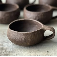 four brown cups sitting on top of a table