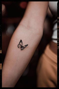 a small butterfly tattoo on the arm