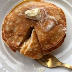 pancakes with butter and syrup on a white plate