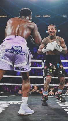 two men standing next to each other in a boxing ring