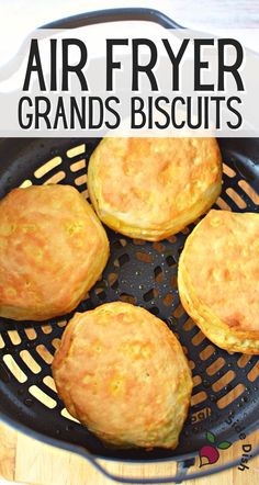 four biscuits in a frying pan with the words air fryer grands biscuits