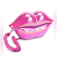 a pink lip shaped object with a telephone cord attached to it's side and the top part of its mouth