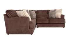 a brown sectional couch with pillows on it's back and the seat facing outward