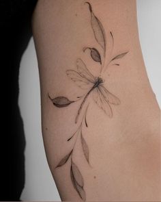 a woman's arm with a flower tattoo on the left side of her body