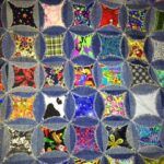 a quilt made with many different colored squares