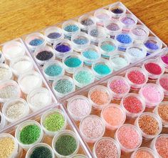 there are many different colors of glitter in the container on the table and next to each other