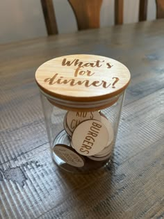 a jar filled with wine corks sitting on top of a wooden table