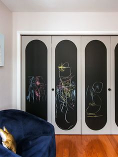 a room with three chalkboards on the wall