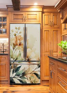 the refrigerator is painted with flowers and leaves on it's side, along with wooden cabinets