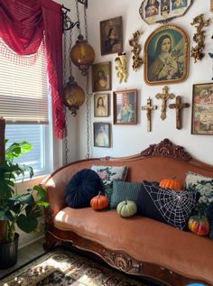 a living room filled with furniture and pictures on the wall