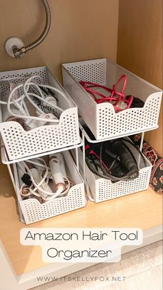 three white baskets filled with shoes sitting on top of a wooden shelf next to a lamp