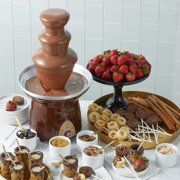 chocolate fountain surrounded by desserts and strawberries