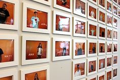 a wall full of people's pictures on orange and white frames with the names of each individual