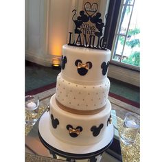 a three tiered cake with mickey mouse decorations