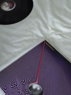 a record player is laying on top of a white sheet