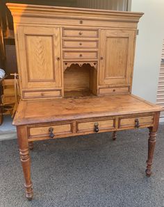 an old wooden desk with drawers and cupboards