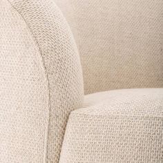 a close up view of the back end of a beige couch with buttons on it