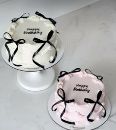 two decorated birthday cakes sitting on top of a counter next to each other, with the words happy birthday written on them