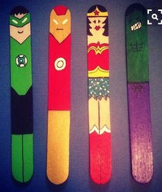 three snow skis with different designs on them are lined up in the shape of superheros