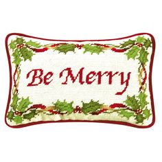 a cross stitch christmas pillow with the words be merry on it's front and bottom