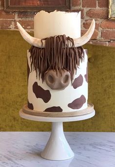 there is a cake decorated with a cow's head on the top of it