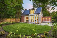 a small backyard with grass and landscaping