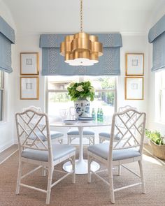 a dining room with blue and white chairs