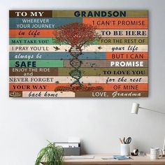 a desk with a plant and some books on it next to a wall mounted canvas