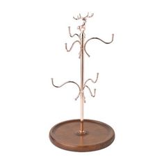 a metal tree on a wooden stand with two hooks attached to the top of it