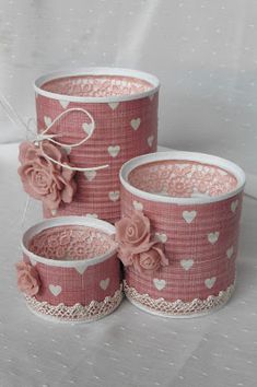 three pink flower pots with hearts and lace on the sides, one is decorated with flowers