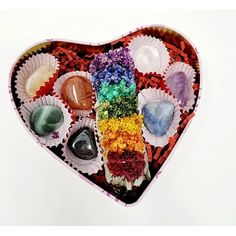 a heart shaped box filled with different colored rocks