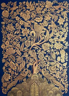 an intricately designed golden tree with birds and flowers on it's blue background