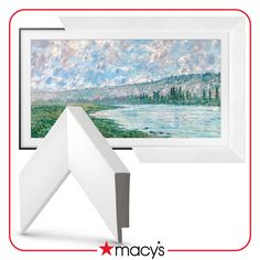 a painting is hanging on the wall next to a white frame with a red border around it