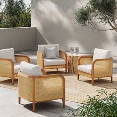 an outdoor living room with wicker furniture