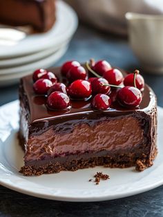 a piece of chocolate cake with cherries on top