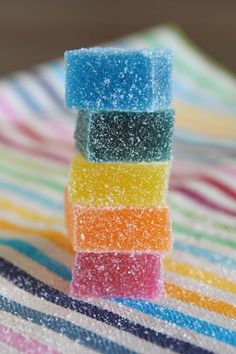 there are many different colored candies stacked on top of each other