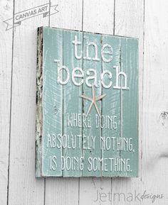 a wooden sign that says the beach where doing absolutely nothing is doing something with starfish on it