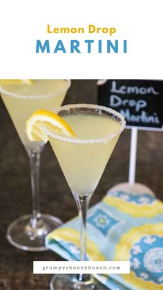 two lemon drop martinis sitting on top of a table