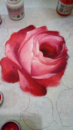 a rose painted on a table with some paint