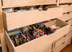 the drawers are filled with pens and pencils