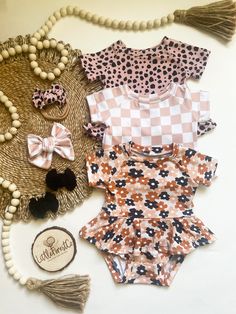 These leos are perfect for any occasion. Whether you dress them up or dress them down to lounge around at home, baby is sure to be comfortable in style!  Material: The floral leo is made with silky soft bamboo.  The checker and spotted leo's are a buttery soft double brushed polyester.  Available in short sleeve or long cuffed sleeve. Playful Fitted Bubble Romper With Short Sleeves, Cute Fitted Bubble Romper For Playdate, Cute Fitted Bubble Romper For Playtime, Cute Printed Fitted Sets, Playful Fitted Bubble Romper For Playdate, Cute Fitted Bodysuit For Playtime, Playful Fitted Bodysuit For Playwear, Playful Fitted Bubble Romper For The Beach, Playful Fitted Bubble Romper For Beach