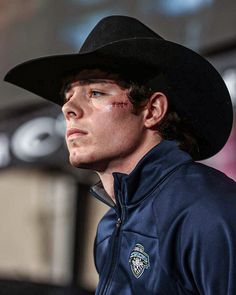 a man wearing a cowboy hat and looking off to the side with his eyes closed