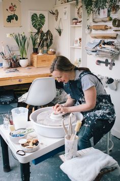 a woman is working on something in her studio