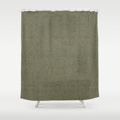 a green shower curtain with an abstract design