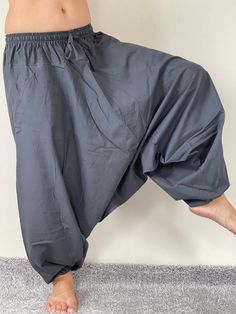 "Harem Pants Ethically Made in Thailand, Low crotch yoga pant, Unisex harem pants, Gorgeous Harem Pants, Lounge & Yoga Trousers Thai Cotton harem pants have the \"flow\", perfect for yoga or just a cool strolling. Comfort and character are what these pants are all about. They have the traditional sarong look & feel but a lot more practical when it comes to activities like yoga. As a bonus, they are convertible! Just pull them up and you get yourself a cute jumpsuit in a flash. Together w Yoga Harem Pants With Drop Crotch, Yoga Harem Pants With Drop Crotch And Relaxed Fit, Relaxed Fit Drop Crotch Harem Pants For Yoga, Baggy Yoga Pants With Drop Crotch, Stretch Cotton Harem Pants For Yoga, Cotton Drop Crotch Harem Pants For Yoga, Relaxed Fit Harem Yoga Pants, Cotton Harem Yoga Pants, Stretch Drop Crotch Harem Pants For Yoga