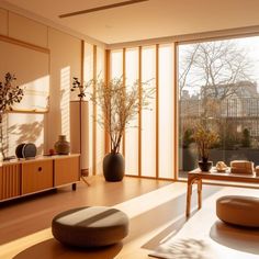 a living room filled with furniture and large windows